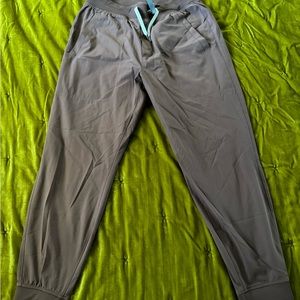 Large Vuori Meta Joggers in Chestnut (Red/Maroon).